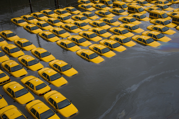 A parking lot full of yellow cabs is flooded as a result of superstorm Sandy in Hoboken, NJ. (Charles Sykes/AP)