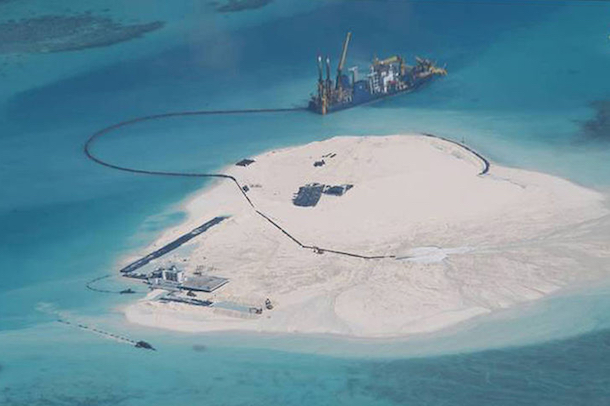 Surveillance photo shows a Chinese vessel expanding structures and land on the Johnson Reef, called Mabini by the Philippines and Chigua by China, at the Spratly Islands in the South China Sea. (Philippine Department of Foreign Affairs)