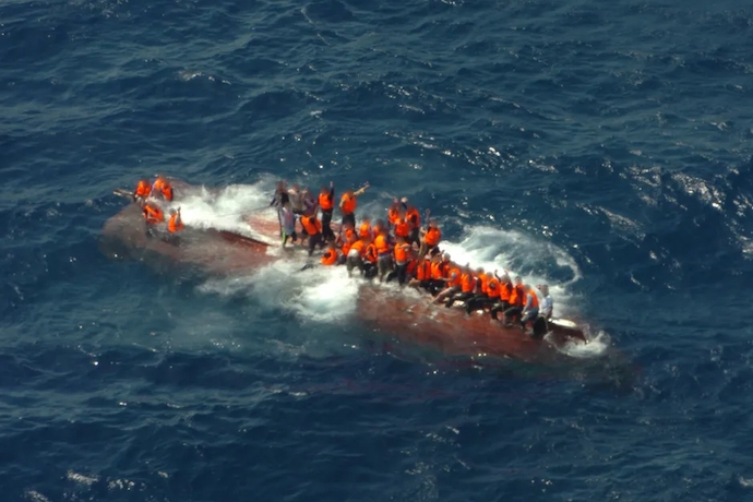 Refugees in overturned boat