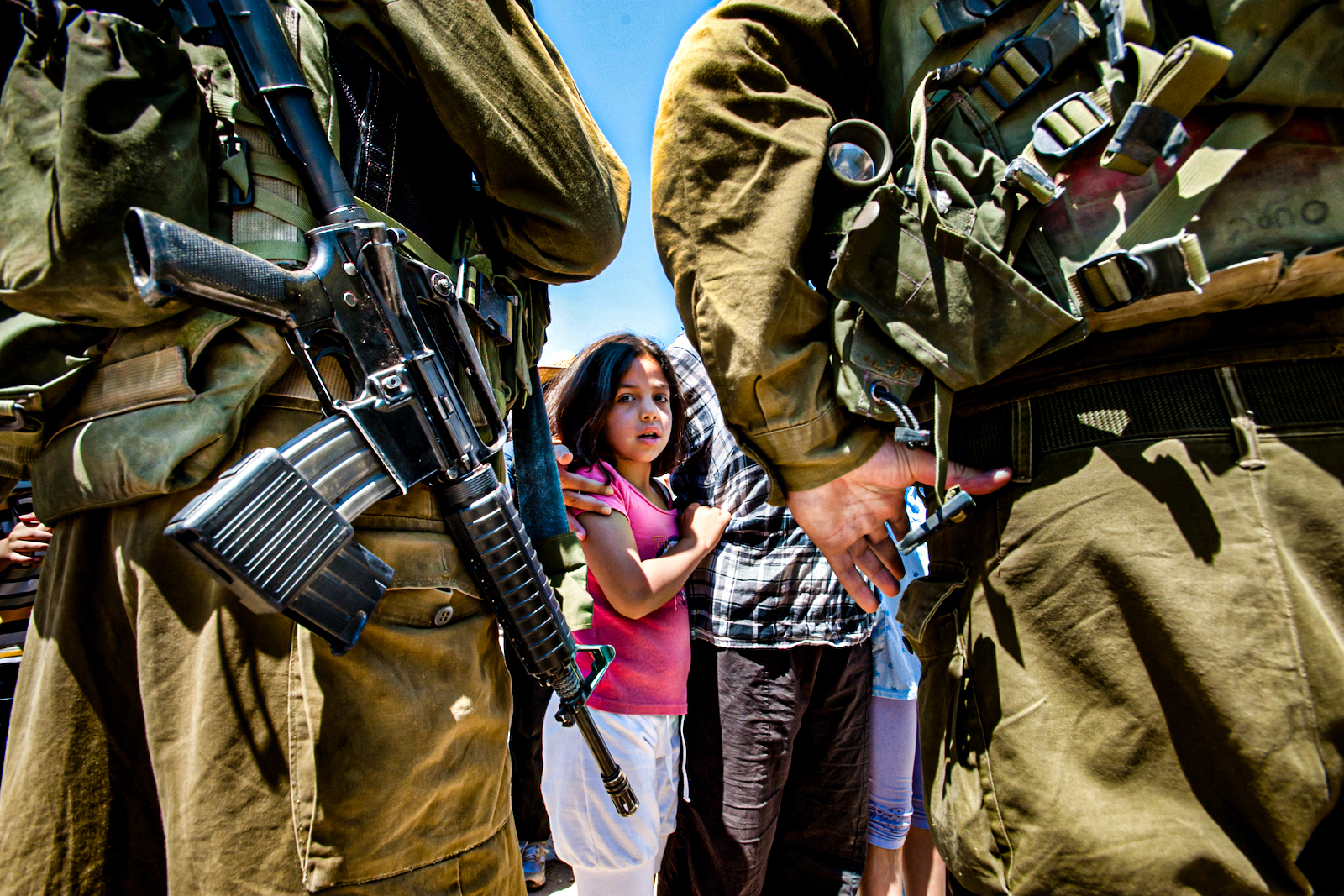 Palestinian girl faces Israeli soldiers in the West Bank