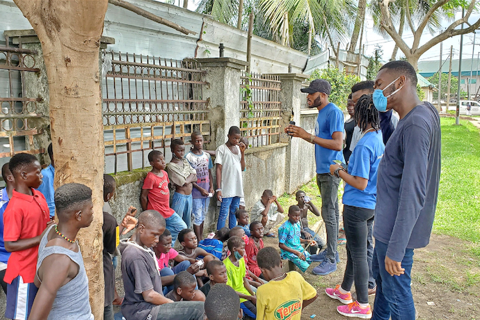 Local children on the streets of Calabar talking with volunteers from Street Priests