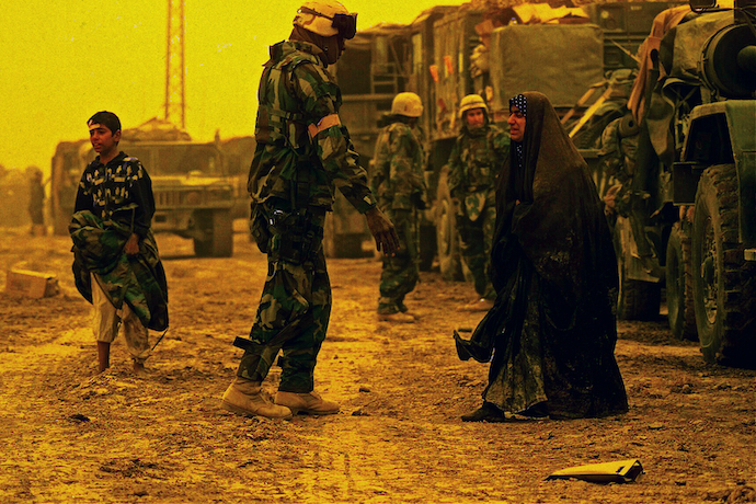 U.S. marines assisting displaced Iraqi civilians north of Al-Nāṣiriyyah, Iraq, during the Iraq War