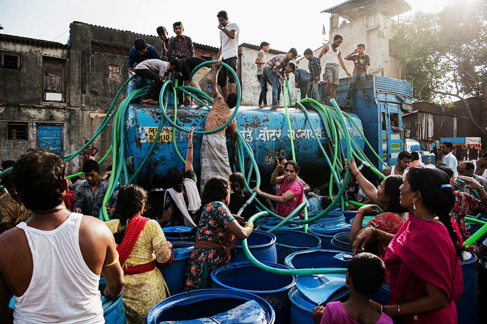 Villagers in Bhiwandi, India climb a municipal water tanker