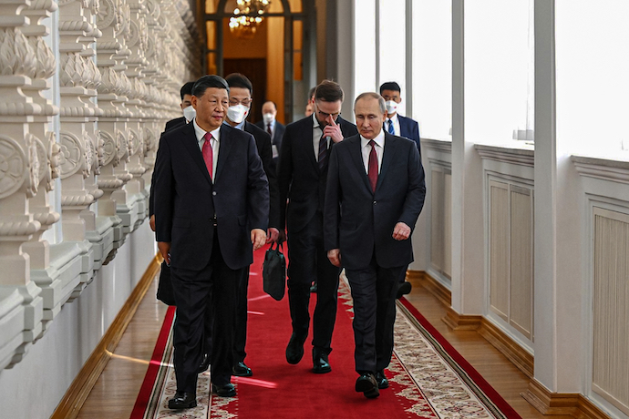 Vladimir Putin talks with Xi Jinping