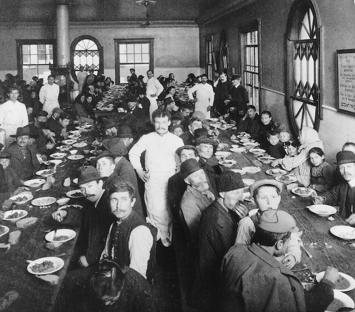 Newly arrived immigrants having dinner at Ellis Island