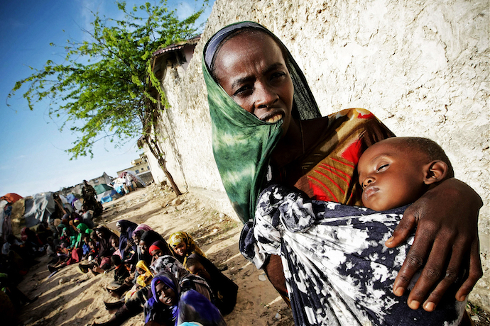 A Somali woman holds her malnourished child waiting for medical assistance from AMISOM in Mogadishu in 2011