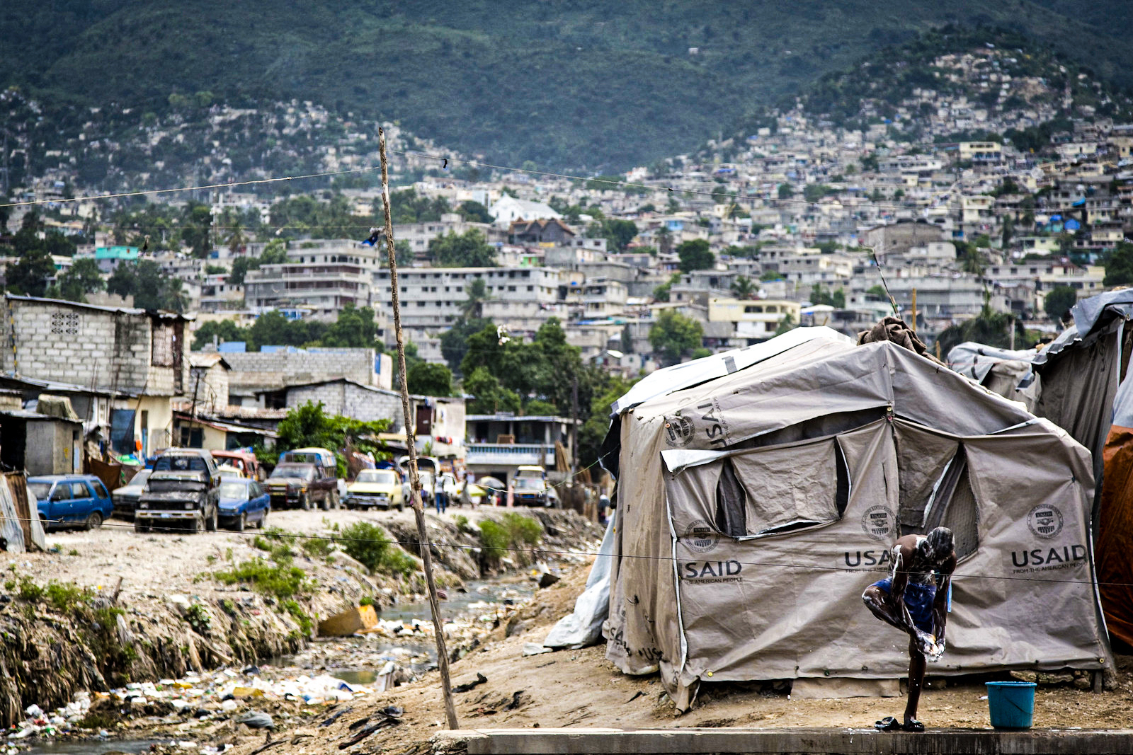 A young man takes a bath in Cité L'Eternel, a poor neighbourhood of Port-au-Prince, Haiti