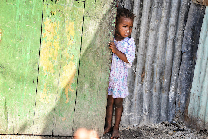 A Haitian girl waits for food aid in 2014