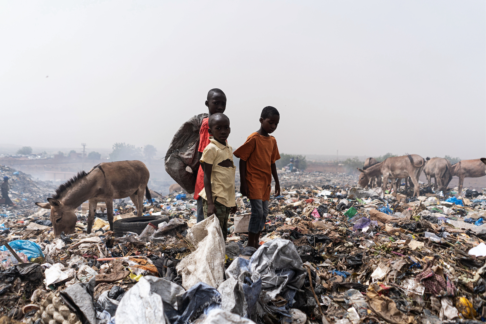 African street kids sorting trash for recyclables