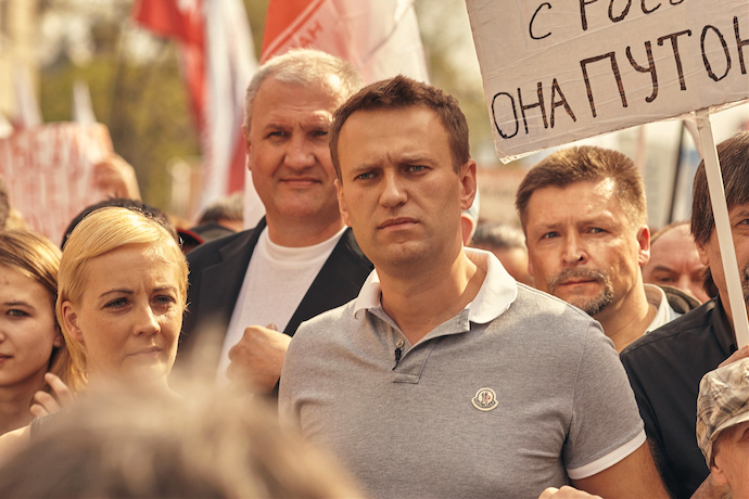 Alexei Navalny marching with his wife Yulia at a protest rally in 2012