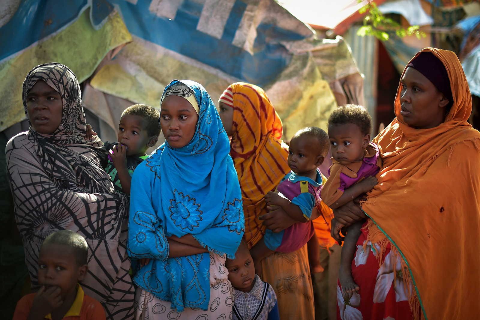 A group of Somali women stand near a water point at a IDP camp in Mogadishu