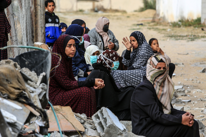 Palestinians at the site of a destroyed home from an Israeli airstrike in Rafah, in the southern Gaza Strip