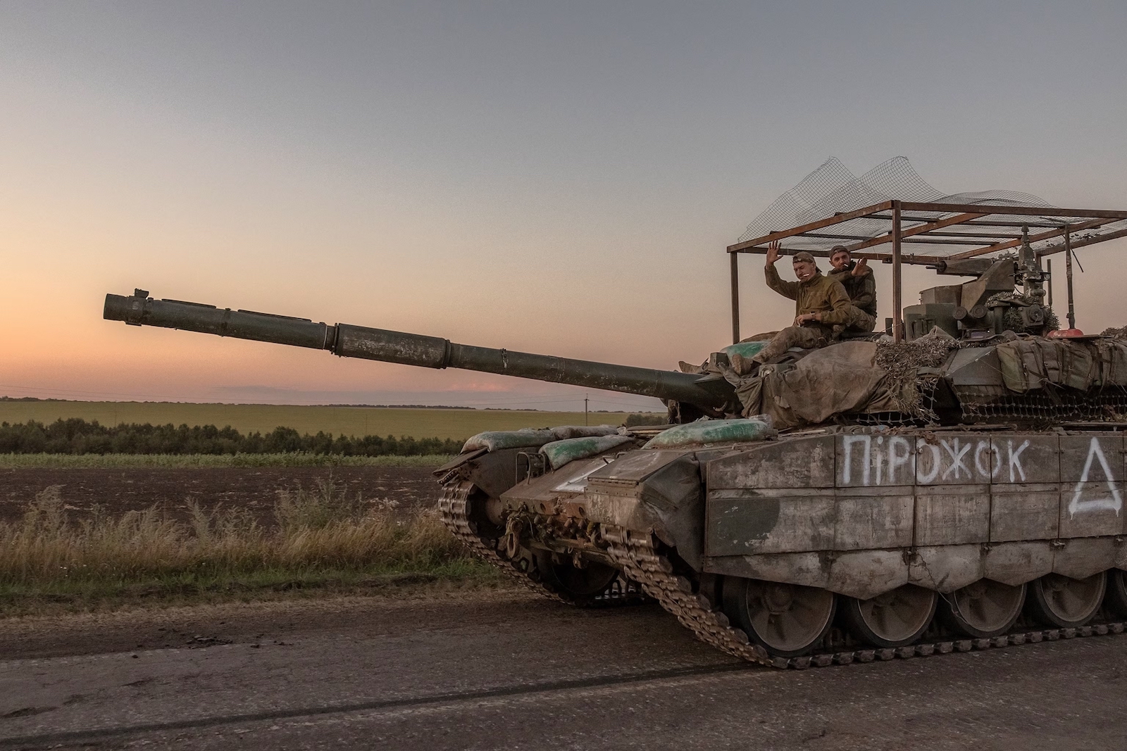 Ukrainian troops riding on top of a captured Russian tank