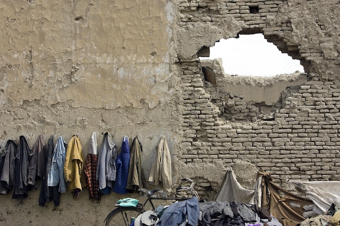 Afghan students' coats hang on the wall outside a school in Kabul in 2011